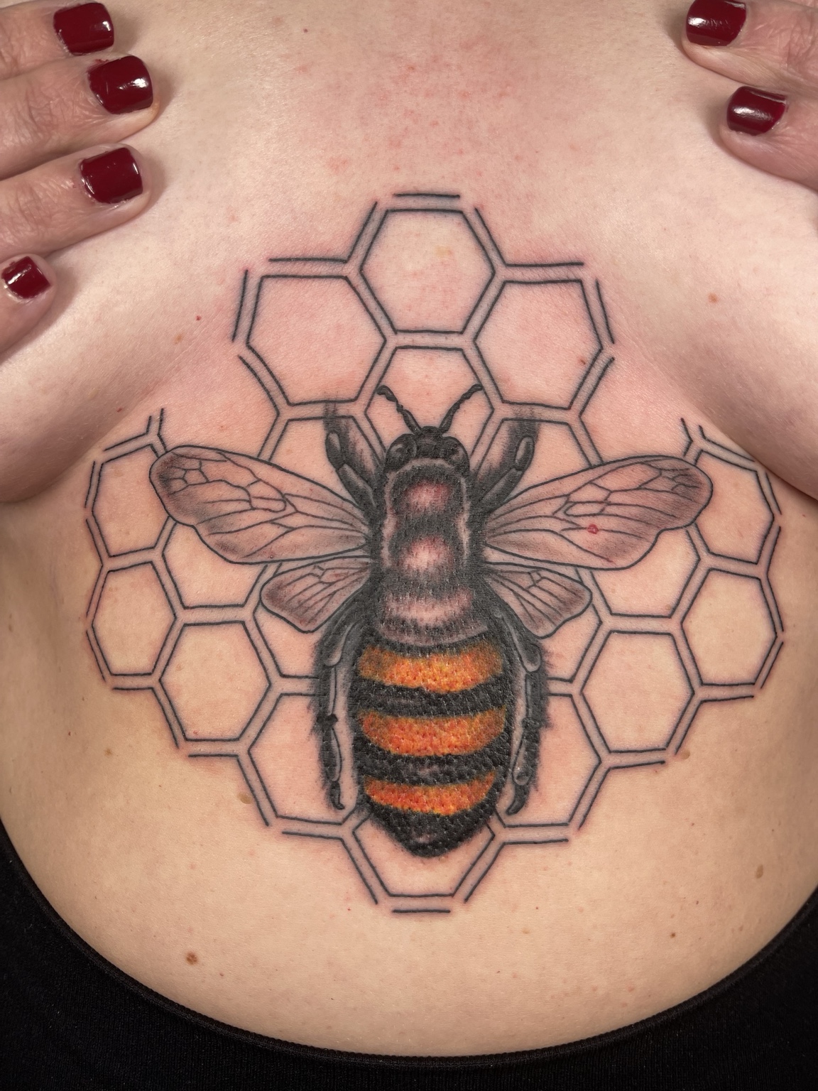 Bee and honeycomb sternum tattoo