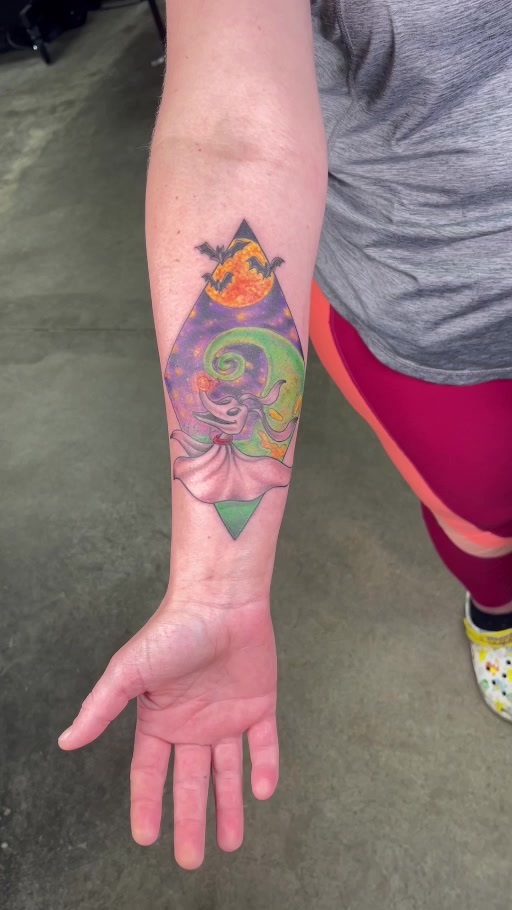 Full color celestial character forearm tattoo