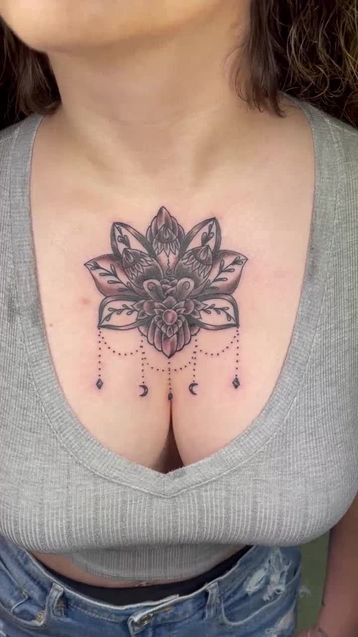 Ornamental black and grey chest tattoo