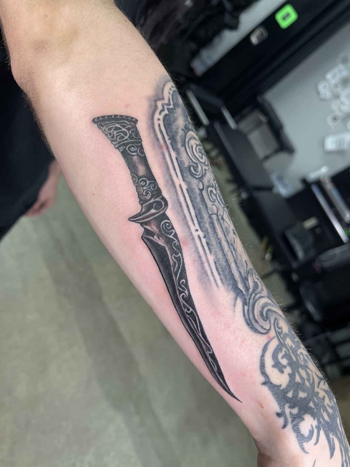 Detailed custom black and grey sword tattoo